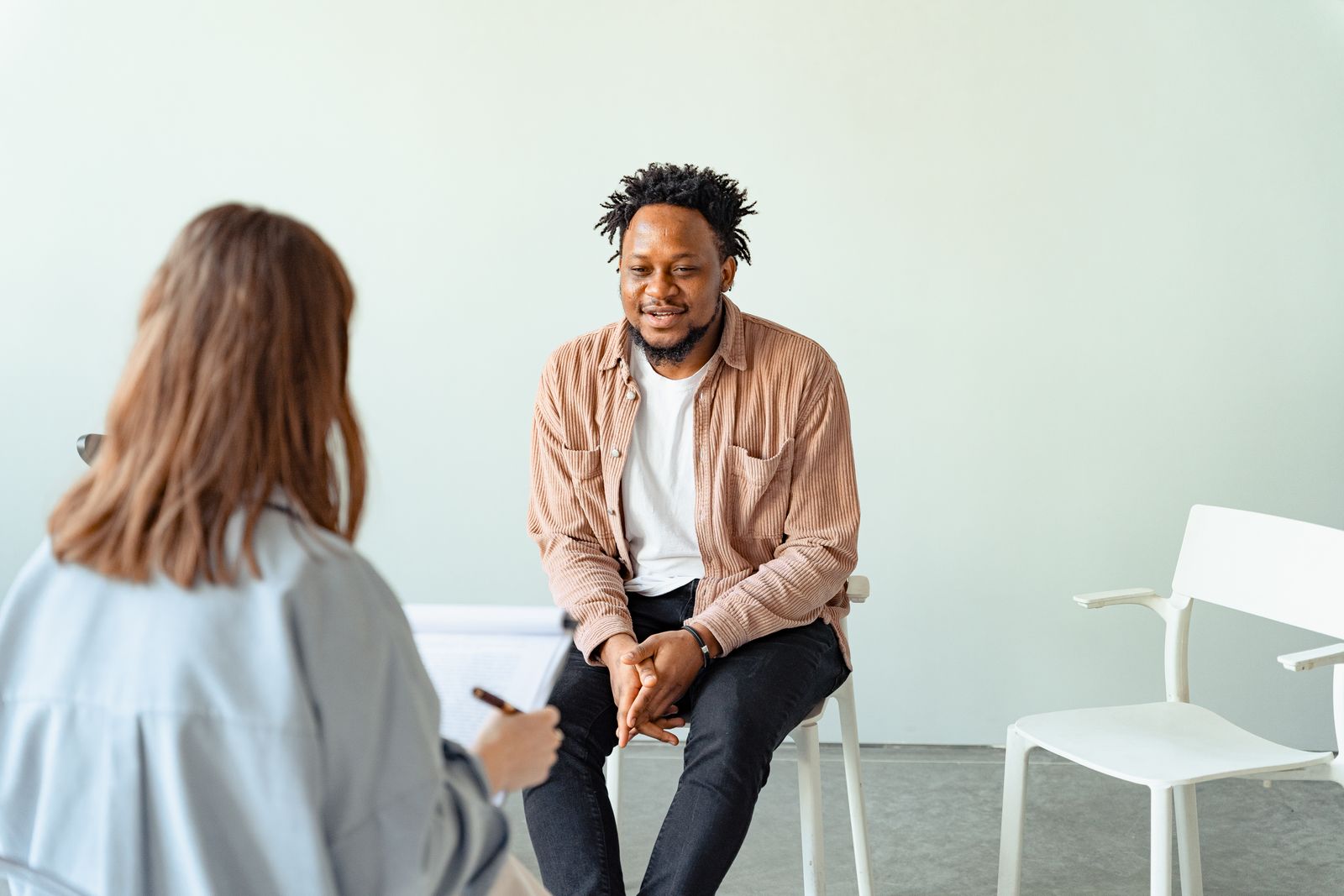 Counselor and client talking in an office.